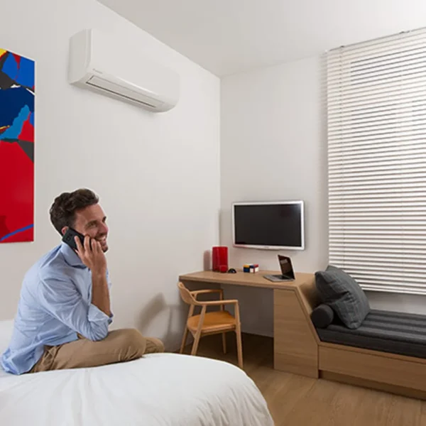 Daikin Sensira indoor wall-mounted air conditioner in white installed in a modern bedroom